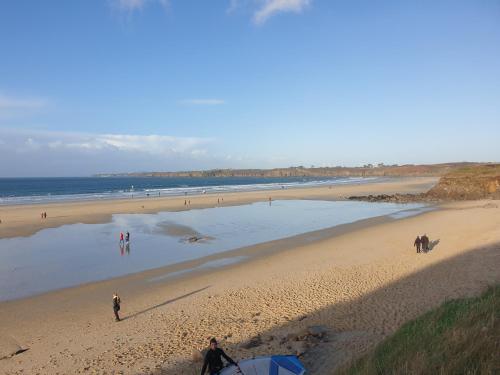 a group of people standing on a beach at Le Drellac'h in Le Conquet