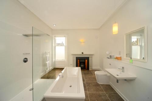 a white bathroom with a sink and a toilet at Greystones B&B in Oban