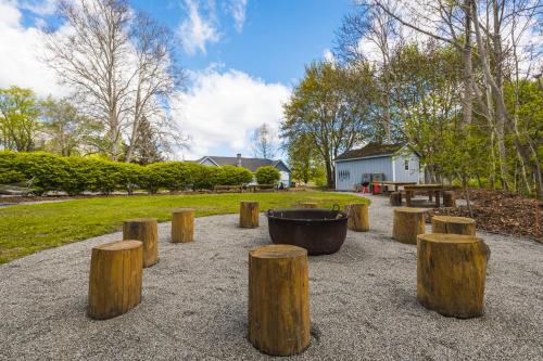 a group of wooden stumps in a park with a bucket at The Grayhaven Motel in Ithaca