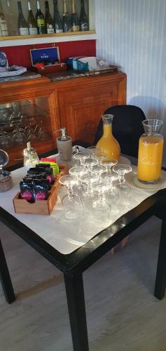 a table with a bunch of wine glasses on it at Hôtel restaurant du Commerce in Poulainville