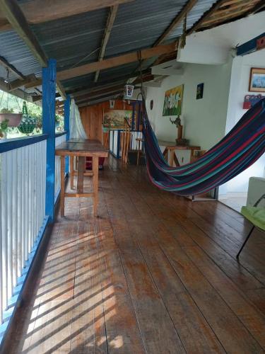 a hammock in the middle of a room at Agradable casa de Campo Villa Maruja. in Palmira