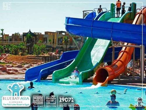a water park with a slide in the water at blue bay sokhna aqua park - مارسيليا بلو باى السخنه -عائلات فقط in Ain Sokhna