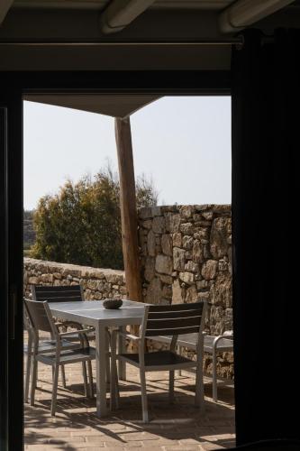 a table and chairs with an umbrella on a patio at Ikies of Mykonos in Mýkonos City