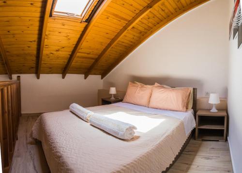 a bedroom with a bed with a wooden ceiling at Olympia studios By Travel Pro Services - Agios Nikolaos Halkidiki in Ayios Nikolaos Sithonia