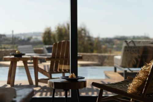a view of a patio with chairs and a table at Ikies of Mykonos in Mýkonos City
