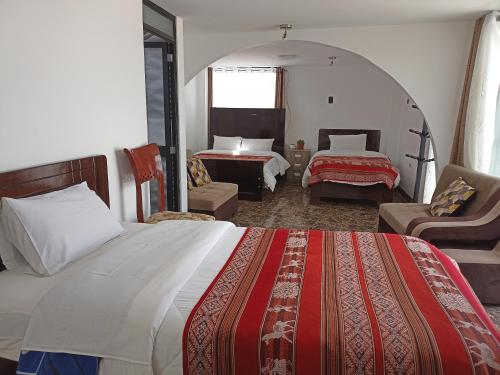 Rúm í herbergi á Hostal Killaly Inn Cusco