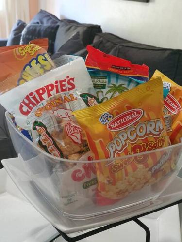 a bowl of chips and snacks on a table at Central Upscale New Kingston Apt with pool in Kingston