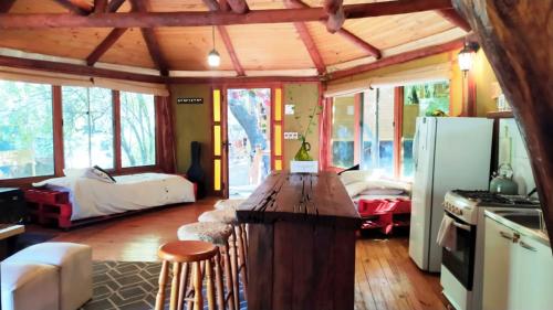 a kitchen with a long wooden table in a room at Cabañas Alegria Cajón del Maipo in San José de Maipo