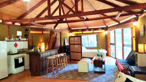 a room with a kitchen and a living room at Cabañas Alegria Cajón del Maipo in San José de Maipo