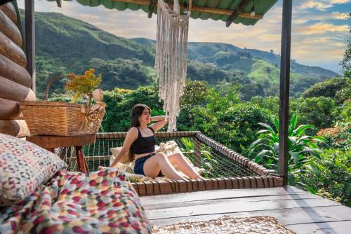 a woman in a black bikini sitting on a porch at BOSQUE EL DESCANSO in Jamundí