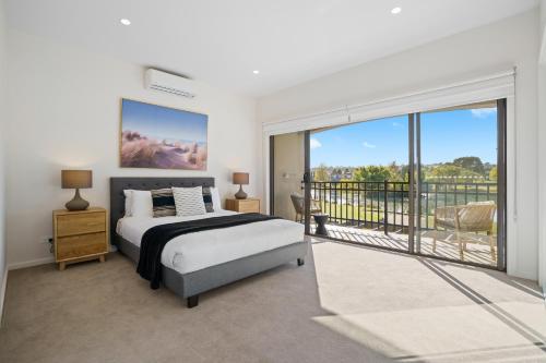 a bedroom with a bed and a balcony at Hidden Valley Resort in Wallan
