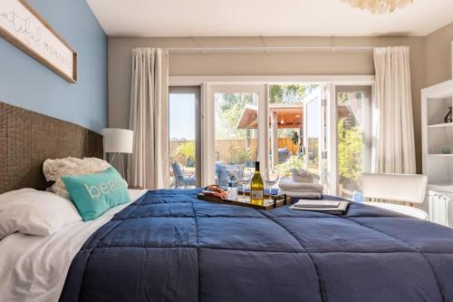 a large bed with a blue comforter in a bedroom at Spacious, Luxury Ocean Master Suite 2 BD With Kitchenette in San Diego