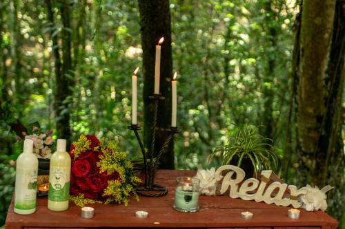 a table with a candle and flowers and a candle holder at BOSQUE EL DESCANSO in Jamundí