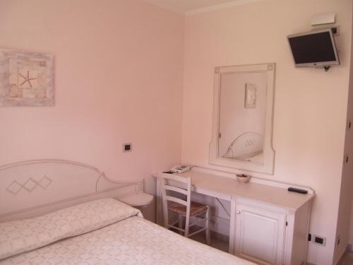 a bedroom with a bed and a desk and a mirror at Residence Panama in Alassio