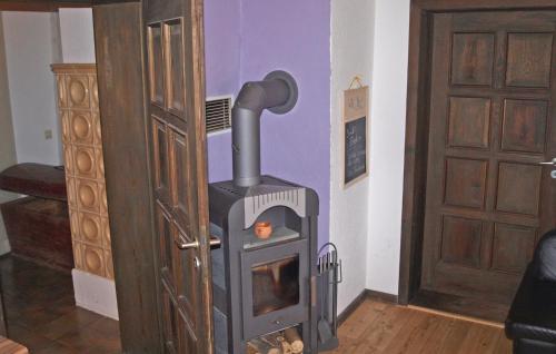 a wood stove in a room next to a door at Awesome Home In Sassnitz With Kitchen in Sassnitz