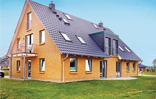 a large brick house with a black roof at Golfpark Strelasund in Kaschow