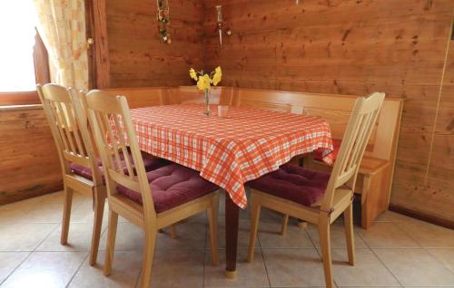 a dining room table with a red and white checkered table cloth at Awesome Apartment In Remptendorf in Gleima