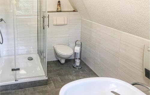 a bathroom with a toilet and a shower and a sink at 2 Bedroom Lovely Home In Lbtheen in Probst Jesar