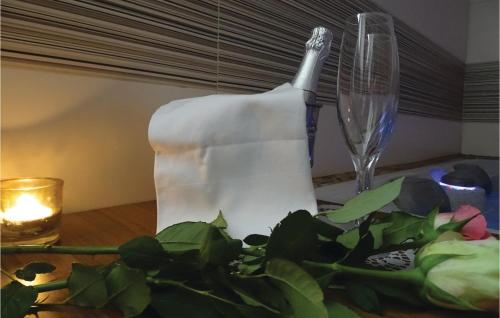 a table with a candle and a glass at Stunning Apartment In Lasko With Wifi in Laško