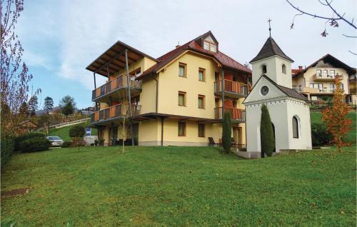 a large building with a clock tower in the yard at Stunning Apartment In Lasko With Wifi in Laško