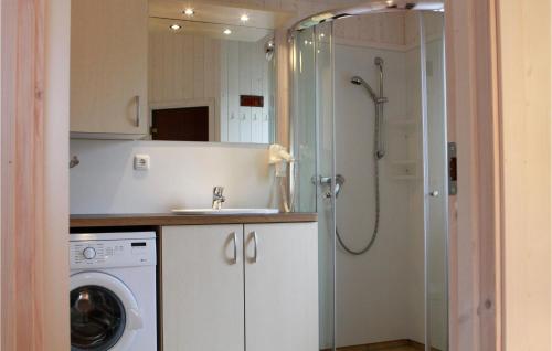 a bathroom with a shower and a sink and a washing machine at Pulverhorn 9 - Dorf 4 in Travemünde