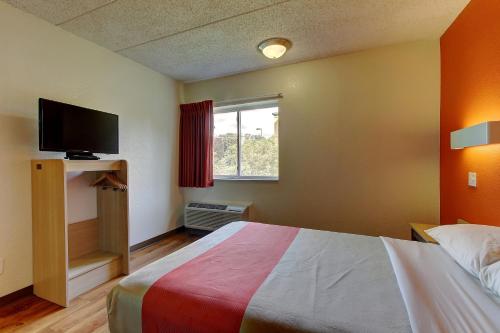 a hotel room with a bed and a television at Motel 6-York, PA - North in York