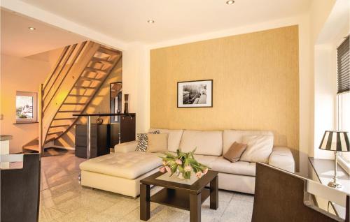 a living room with a couch and a table at Cozy Home In Pinnow With Wifi in Petersberg