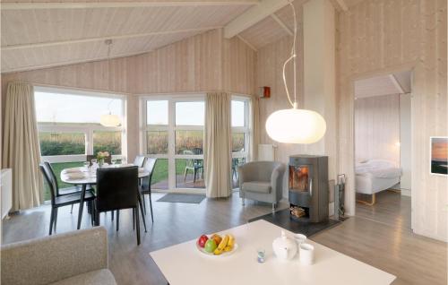 a living room with a dining table and a fireplace at Friedrichskoog-Strandpark 9 in Friedrichskoog