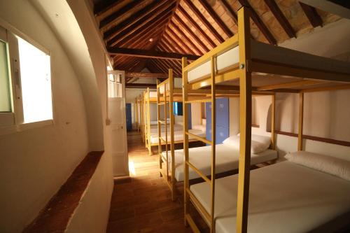a group of bunk beds in a room at Wake up in Tarifa Hostel & Restaurant Lounge in Tarifa