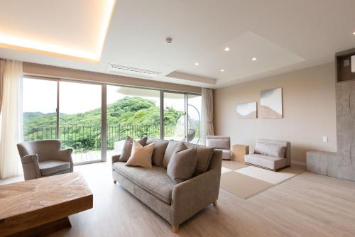 a living room with a couch and a table at HOTEL天 -Tin- in Ujimi