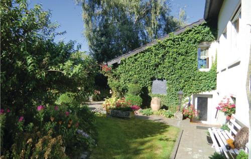 a house covered in green ivy with a garden at Awesome Apartment In Nusbaum With Wifi in Nusbaum