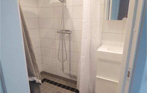 a bathroom with a shower and a sink at Cozy Home In Kvicksund With Sauna in Kvicksund