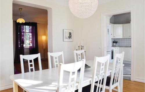 a white dining room with a white table and chairs at 2 Bedroom Gorgeous Apartment In Ystad in Ystad
