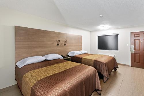 Postel nebo postele na pokoji v ubytování Siesta Inn McAllen