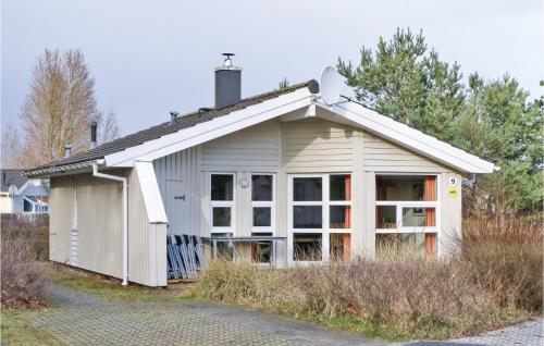 a small white building with a large window at Frische Brise 9 - Dorf 2 in Priwall