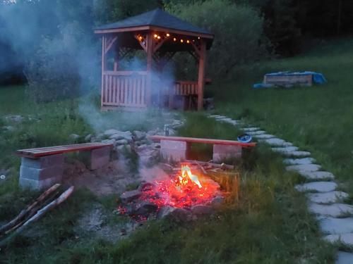 a fire pit in a yard with a gazebo at Villa Eva & Lilou Pod Rysianką in Żabnica