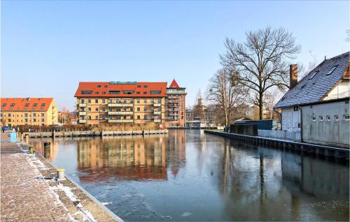 un río en una ciudad con edificios y edificios en Stunning Ship In Neuruppin With House Sea View, en Neustrelitz