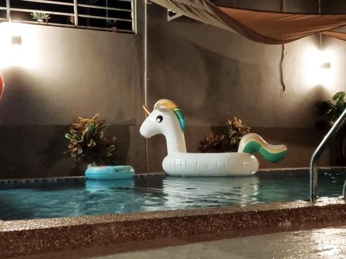 a inflatable unicorn in the water in a pool at Private pool Cassa Dinies, Wifi , Bbq,10 pax in Rantau Panjang