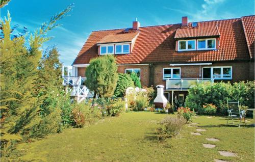 a house with a garden in front of it at Beautiful Apartment In Kühlungsborn in Kühlungsborn