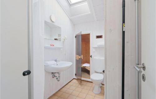a bathroom with a toilet and a sink at Abendrot 3 - Dorf 3 in Priwall