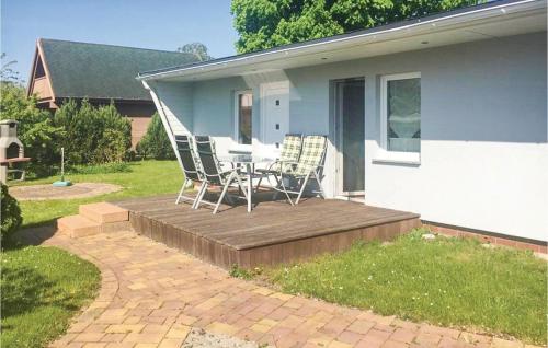 a table and chairs sitting on a wooden deck at Holiday Home Dranske Alte Gärtnerei in Dranske