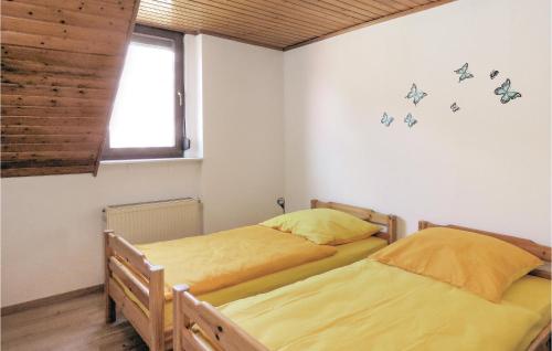 two twin beds in a room with a window at Gorgeous Apartment In Lahnstein With Kitchen in Lahnstein