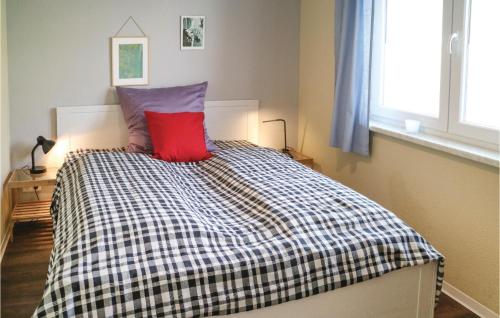 sypialnia z łóżkiem z czerwoną poduszką w obiekcie Stunning Apartment In Gelbensande With Kitchen w mieście Graal-Müritz