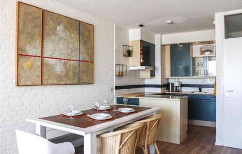a kitchen with a table with two plates on it at 2 Bedroom Stunning Home In Bruinisse in Bruinisse