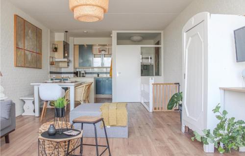 a living room and kitchen with a couch and a table at 2 Bedroom Stunning Home In Bruinisse in Bruinisse