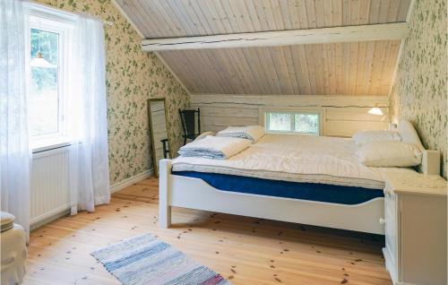 a bedroom with a bed with a wooden ceiling at Beautiful Home In Värnamo With Wifi in Värnamo