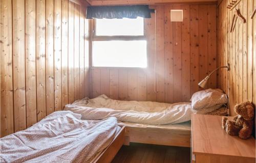 a room with two beds in a wooden wall at 2 Bedroom Beautiful Home In Trysil in Trysil