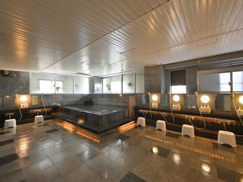 那覇市にあるホテルサン沖縄の大きなバスルーム(バスタブ、椅子付)