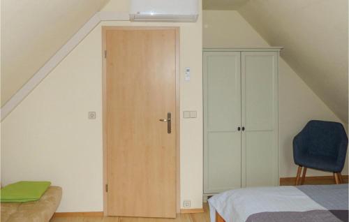 a bedroom with a wooden door in a attic at 2 Bedroom Awesome Home In Woldegk in Woldegk