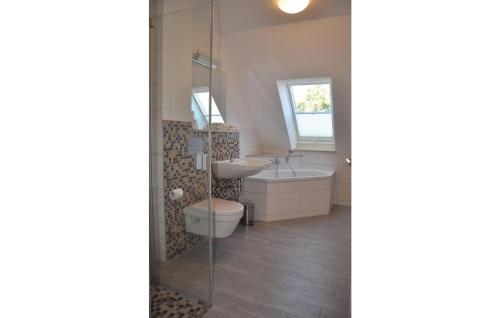 a bathroom with a toilet and a sink and a shower at Fewo Schloss Schwerin in Kaschow